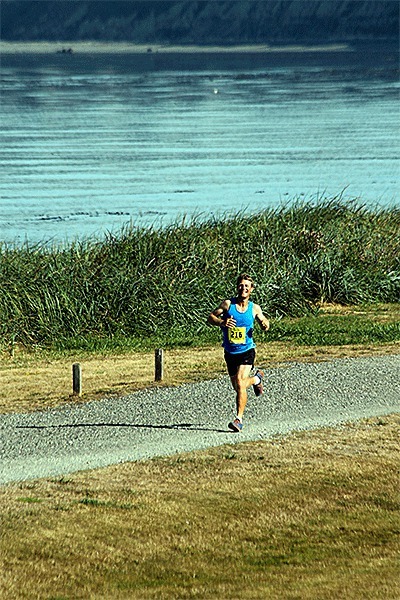 Ryan Prachnau runs through Camp Casey on the way to winning the Race the Reserve half marathon.