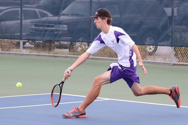 Jackson Wezeman chases down a ball in Monday's match with Arlington. Wezeman won in first singles 6-3