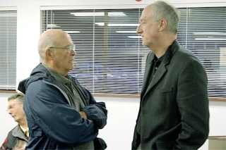 Oak Harbor resident Fred Henninger talks with Island County Commissioner John Dean before a forum Wednesday night at the Heller Road Fire Station.