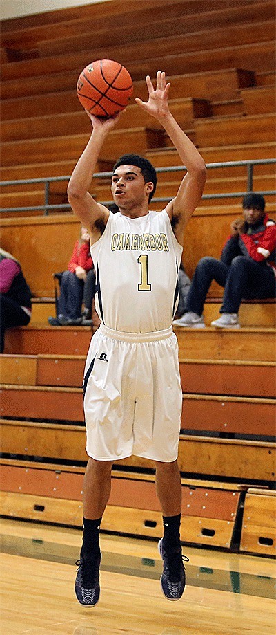 Dyllan Harris puts up a three-point shot for Oak Harbor Monday. Harris hit eight three-pointers on the way to scoring 40 points.