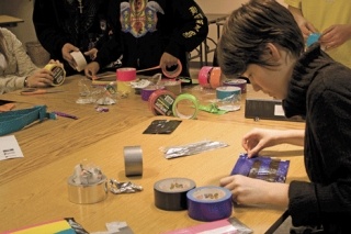 Carefully adding another strip of tape to create a wallet