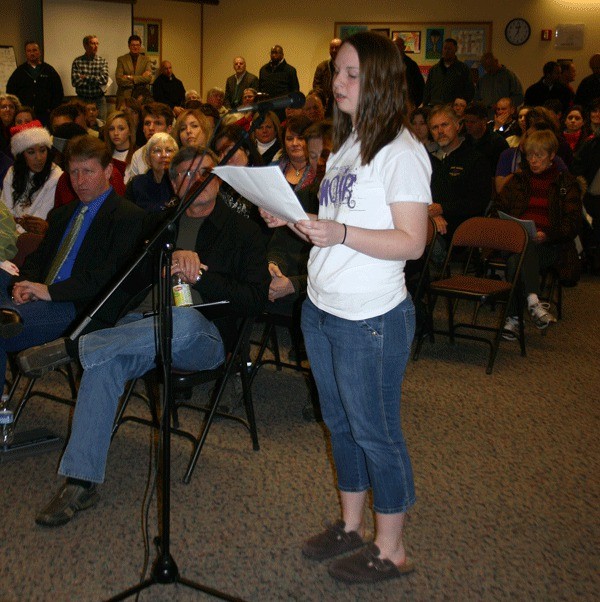 Oak Harbor High School choir student Katie McClimans explains how the choir club has helped her as the school board fields comments Monday night on the future levy request.