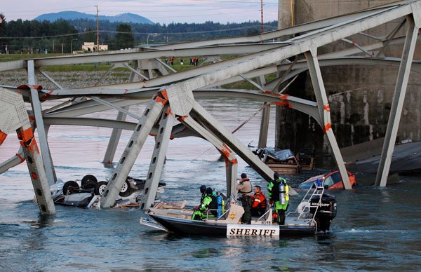 Rescuers search for victims of the bridge collapse on Interstate 5 in Skagit County. Three people suffered minor injuries.