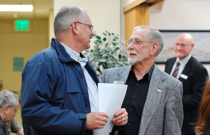 Political hopeful William (Skip) Pohtilla speaks with Oak Harbor City Councilman Jim Campbell after a special meeting Monday. Four finalists were selected for position 5 on the council.