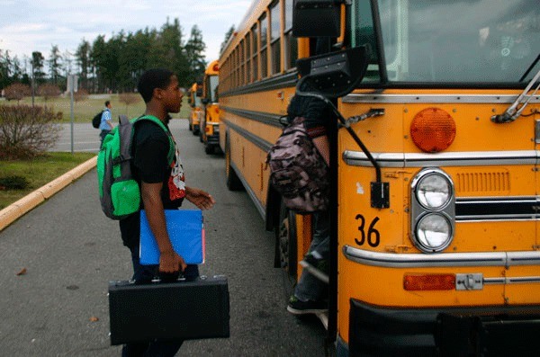 Princeton Lollar gets on the school bus at North Whidbey Middle School. The school board will discuss transportation funding at a meeting Monday.