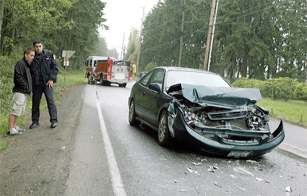 A Coupeville deputy marshal and the driver of a Honda that rear-ended a Ford F150 in front of the Solid Waste Complex survey the damage after the two-car rear-end accident near 20018 Highway 20 at about 3 p.m. Wednesday. Both airbags in the Honda deployed. A woman in the Ford was transported to the hospital in a Whidbey General EMS unit for unknown injuries. A man was also in the Ford