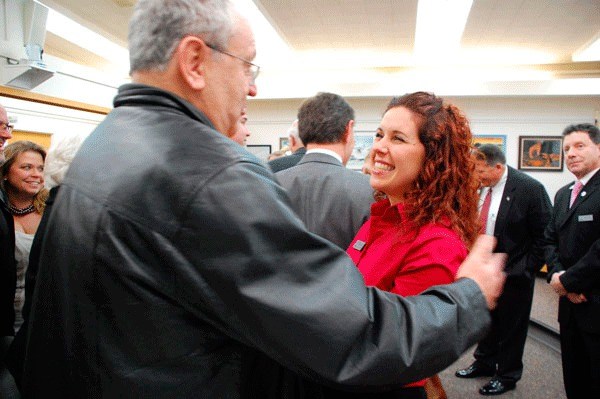 Political rival Paul Brewer congratulates newly elected Oak Harbor City Councilwoman Tara Hizon moments after she and other elected officials were ceremonially sworn in at City Hall Tuesday.