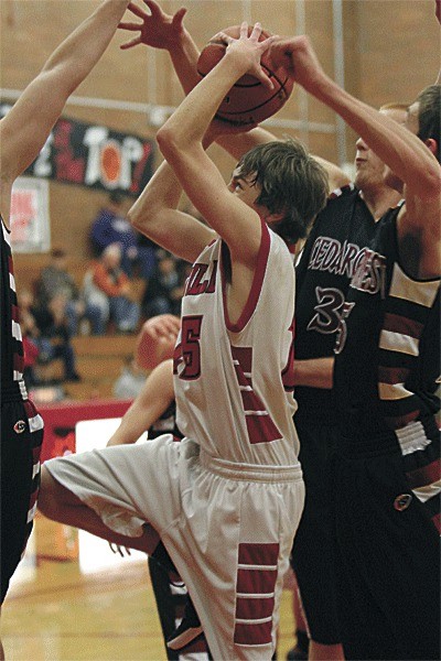 Coupeville's Aaron Curtin fights through the arms of three Cedarcrest defenders.