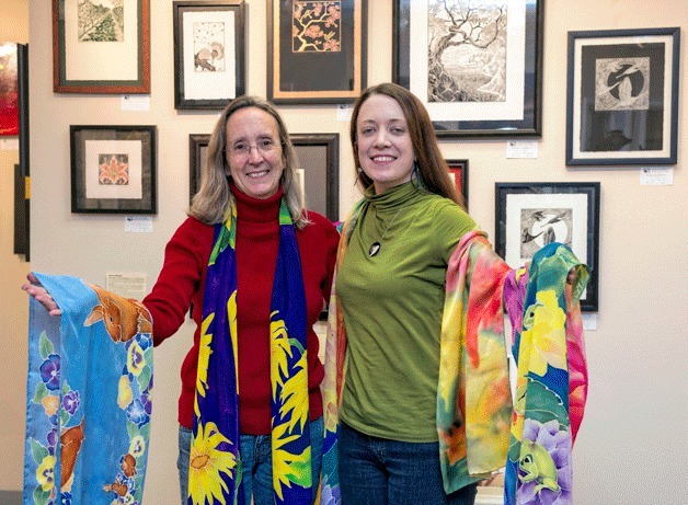 Mary Ellen O’Connor and daughter Linnane Armstrong will participate in Made Right on Whidbey Dec. 15 and 16. Pictured are O’Connor’s hand-painted silk scarves and on the wall are Armstrong’s prints.