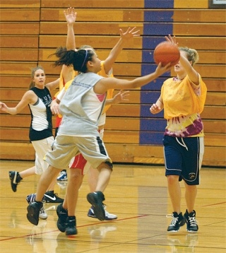 Oak Harbor senior Cheyenne Tubo drives hard to the basket and gets off  a scoop shot good for two points during an early-season practice session.