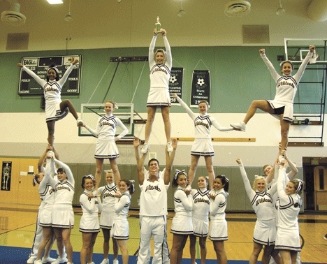 The Oak Harbor cheer squad shows off their first-place trophy.