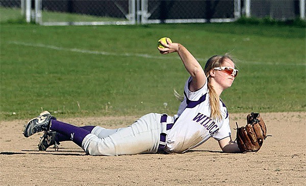 Oak Harbor second baseman Kelly Findley knocks down a line drive and fires to first for the out.