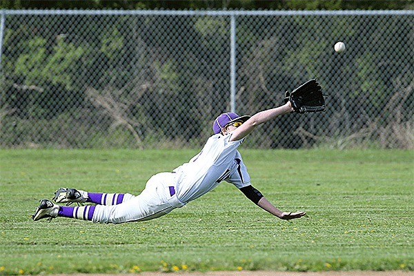 Oak Harbor center fielder Dylan Bailey dives to catch a fly ball.