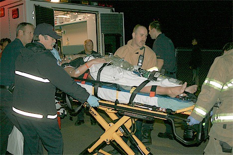 Emergency personnel prepare one of the crash victims for an airlift to Harborview Medical Center