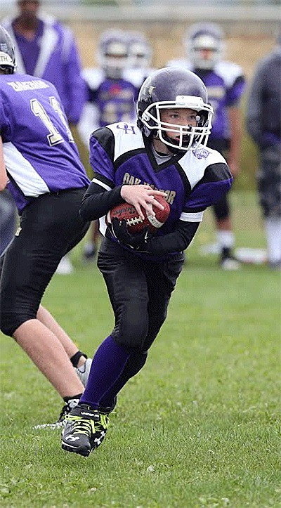 Timothy Steinke carries the ball for the Oak Harbor seniors against Sedro-Woolley at the jamboree Saturday.