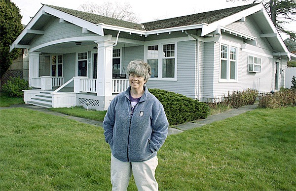 Lavender Wind Farm owner Sarah Richards stands on the lawn of a home she is converting into a commercial kitchen and retail space. She hopes a change in the town’s regulations will retain the green space rather than convert it to parking spaces.