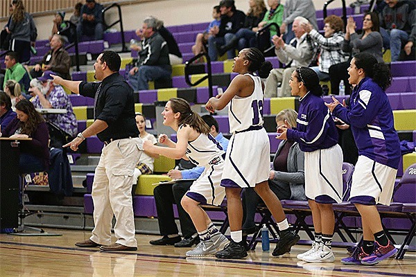 The Oak Harbor bench reacts to a big bucket in the second quarter in the Wildcats' win Monday. From left are coach Jon Atkins