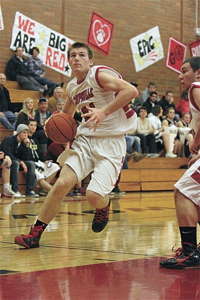 Kole Kellison powers to the hoop with the help of a screen by Drew Chan.