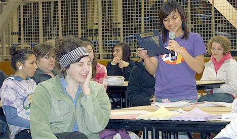 Junior Mariah Ferguson smiles as a club officer reads a thank you letter for a Key Club projects at a meeting Monday.