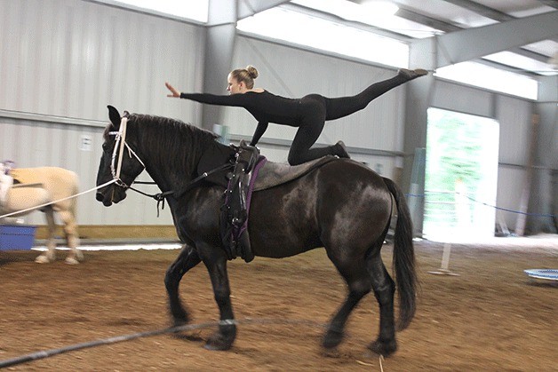 Vaulting team member Kyrsten Tabada demonstrates a compulsory vaulting move on the back of 16-year-old Kirbey. Below