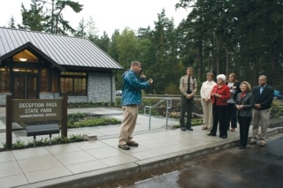 Assistant Regional Manager for Resource Stewardship John Krambrink talks about the importance of the new Deception Pass Ranger Station last Friday. Listening from the left are Ranger Jack Hartt