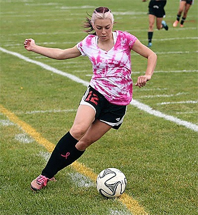 Kirsten Pelroy attempts to save a ball along the sideline for the Wolves.