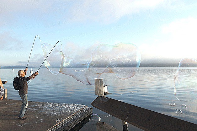 Tom Lindsay creates bubble sculptures at Langley Marina. Lindsay uses an original system of biodegradable soap