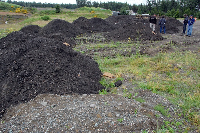 State officials look at the Pit Road site last year shortly after Native American remains were found on Pioneer Way.