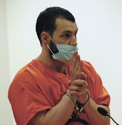 Oak Harbor resident Joshua Lambert wears a spit mask while speaking at his sentencing hearing Tuesday. He was sent to prison for 100 years for murder and kidnapping.