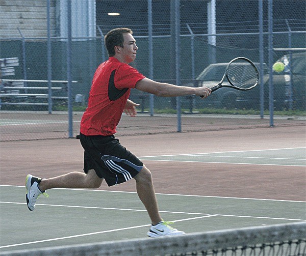 Ben Wehrman slaps a backhand on the way to winning second singles over Friday Harbor.