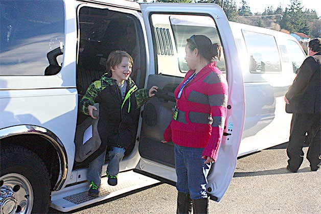 Hillcrest Elementary School first-grade student Trevor Jones exits a limo after a ride last year