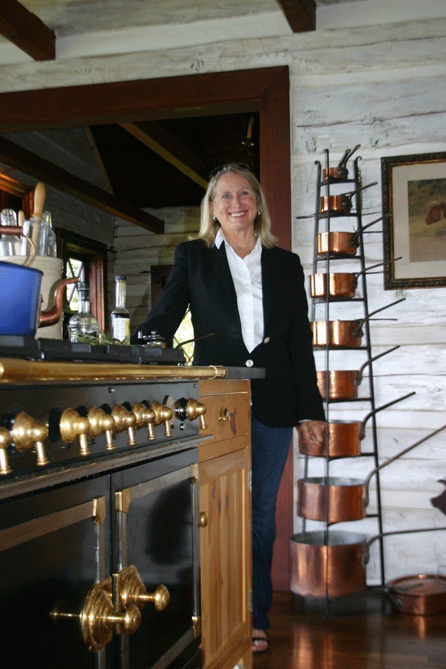 Rebecca Olson / Whidbey News-Times Gaye Santos’ home features French-inspired items like the stove at right and the pot rack in the background. When researching the sea captain who built the home