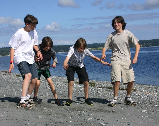 Members of the 4-HD Video Club finish filming for their earthquake disaster preparedness video that will debut at the Whidbey Island Fair Aug. 16 through 19. They are filming a segment about what to do if caught on a beach when an earthquake strikes. From left to right are Isaac Cash