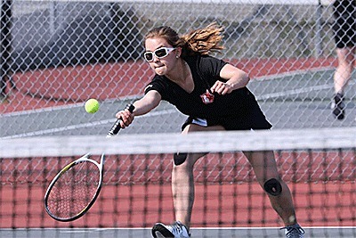 Valen Trujillo hustles to return a ball in her win in the Chimacum match Friday.