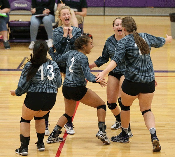 Oak Harbor celebrates after defeating Marysville Getchell Tuesday. From left are Andrea Ruben