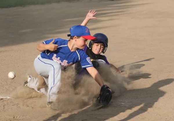 Aiden Golden slides safely into third moments after hitting a three-run double.