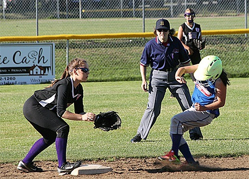 North/Central Whidbey shortstop Ariana Bickley waits for a throw at second base while umpire Rita Cline and right fielder Abby Muholland look on.