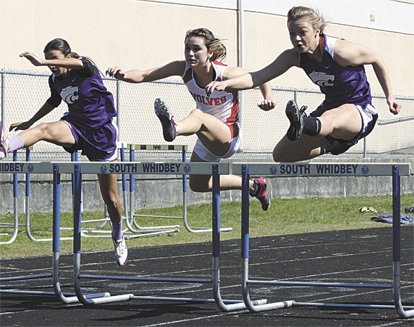 Coupeville's Madison Tisa-McPhee runs between Oak Harbor's Nalani Gabbert