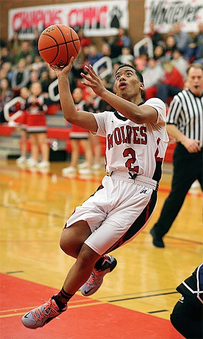 Coupeville's Risen Johnson slides by the La Conner defense for a shot.