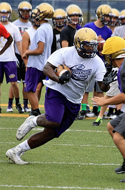 Princeton Lollar looks for daylight in a drill at practice Thursday.