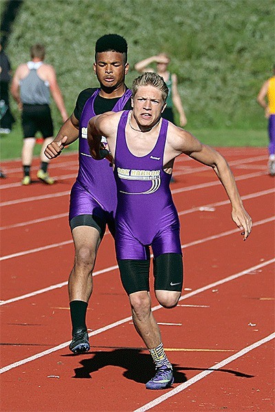 Andrew Miller receives a hand off from Jordan Washington during the 4x100 relay Friday. The Wildcats placed second in the event.