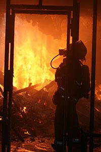 A firefighter extinguishes a fire inside of the late Doroty Neil’s house