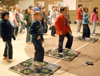 Levy funded P.E. teacher Jeff Pryor teaches students dance moves on Dance Dance Revolution at Broad View Elementary