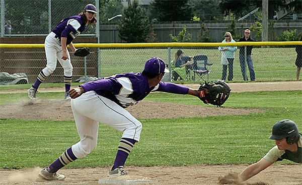 Oak Harbor pitcher Tyler Snavely throws to first baseman Kamren Mebane in an atempt to pickoff a Marysville Getchell runner.