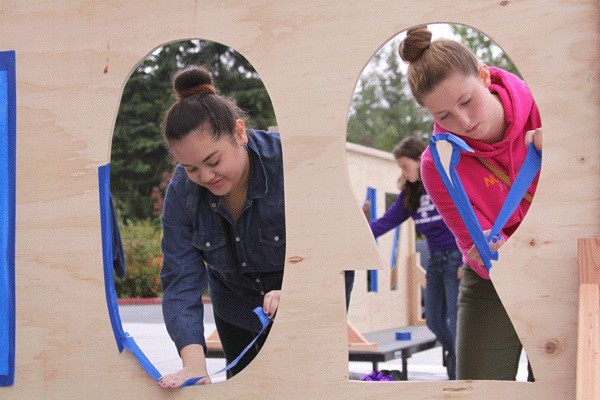 Oak Harbor High School students prepare to paint one of six school floats that will be part of the homecoming parade through downtown Oak Harbor at 5:30 p.m.Wednesday