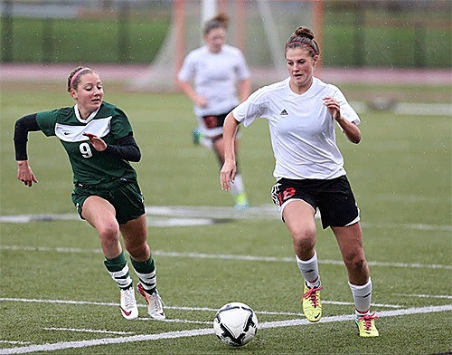 Coupeville's Lindsey Roberts races by Vashon Island's Lauren Jenks.