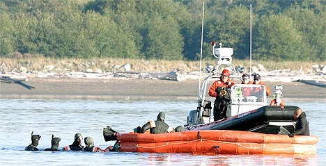 A North Whidbey Fire and Rescue crew assists members of VP-69 during a survival and response preparedness exercise in Crescent Harbor earlier this month.