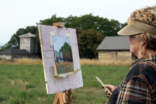 Jayne Quig of Vashon works with pastels to capture an Ebey’s Prairie farmscape in Coupeville Wednesday as part of the Northwest Pastel Society’s Paint-Out.