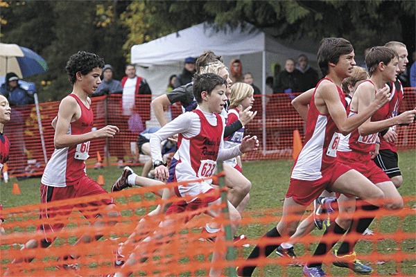 The WIRC youth boys (13/14) team runs in a pack at the Junior Olympic Western Washington championship last Saturday and qualifies for the regional meet. The WIRC runners (red jerseys) from the left are Joey Jepsen (barely visible)