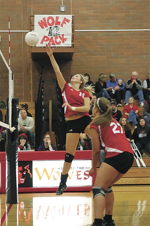 Makenna Martyn tips for Coupeville in its big win over South Whidbey Thursday. Bessie Walstad (27) looks on.